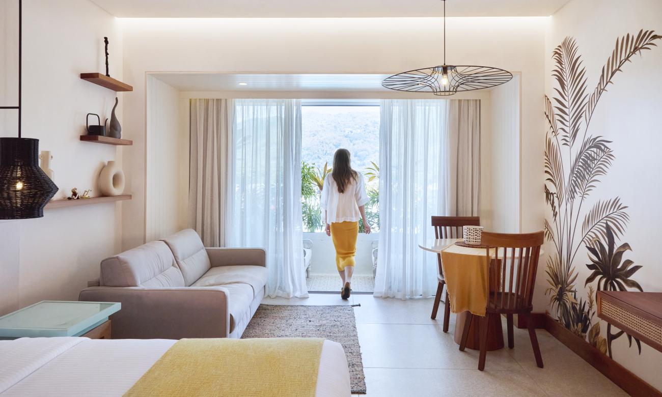 Girl walking onto Junior Suite balcony